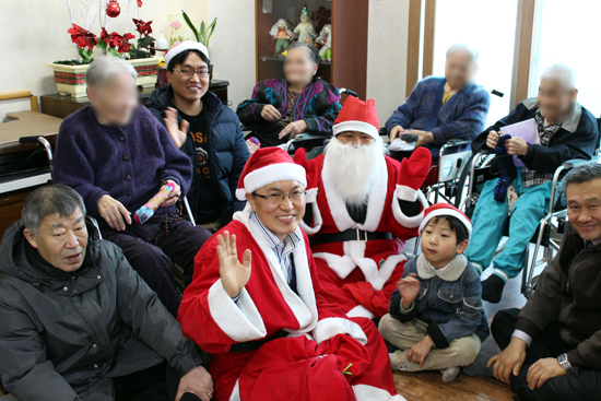 애덕봉사회가 산타클로스가 돼 성가정 노인복지센터에서 노인들에게 선물을 주고 있다.